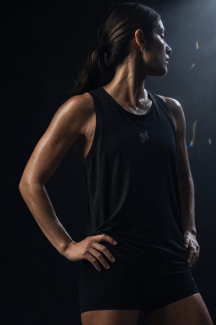 Woman running in the Yeah Buddy black singlet